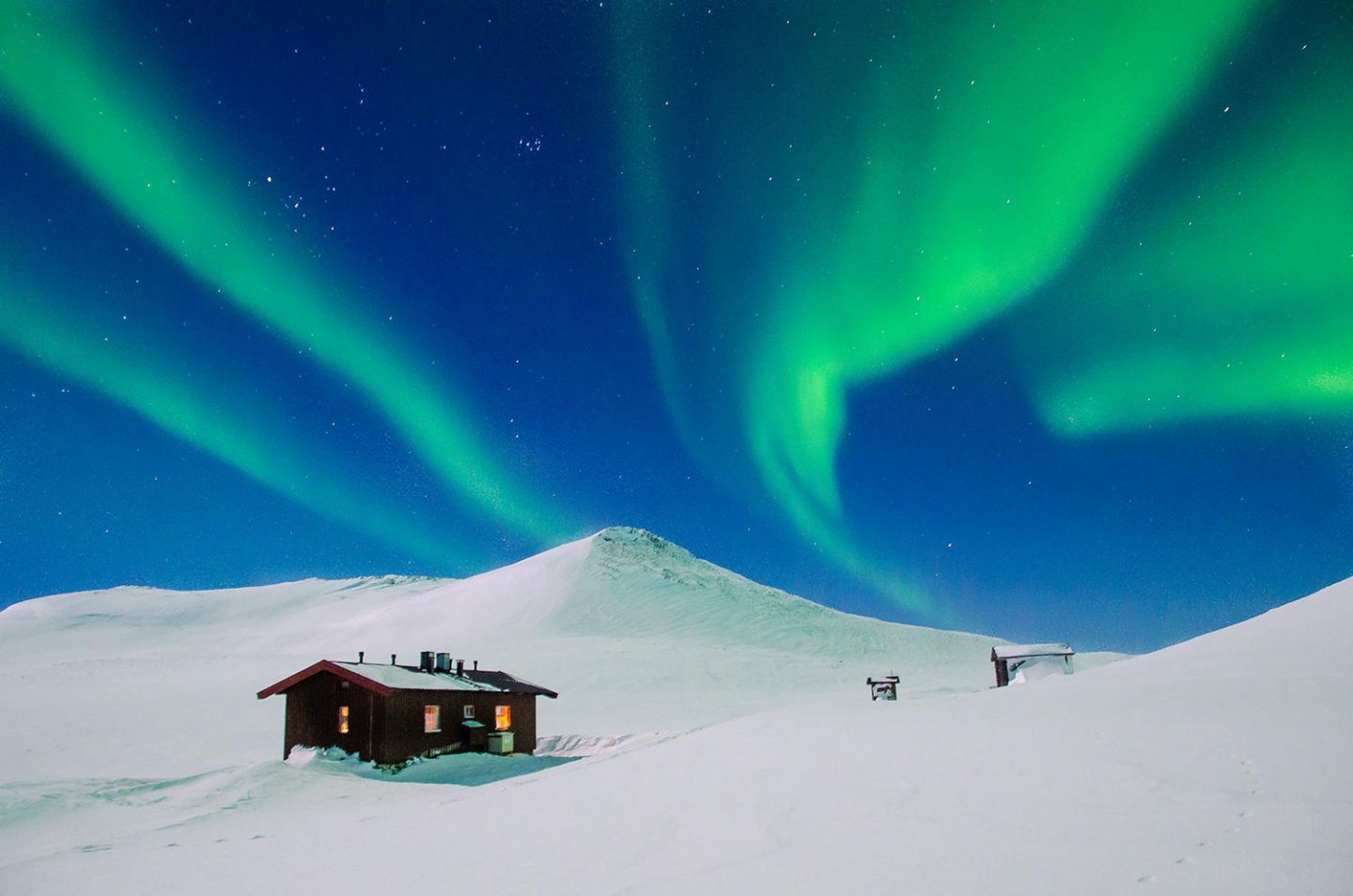 Auroras over a cabin in Lapland